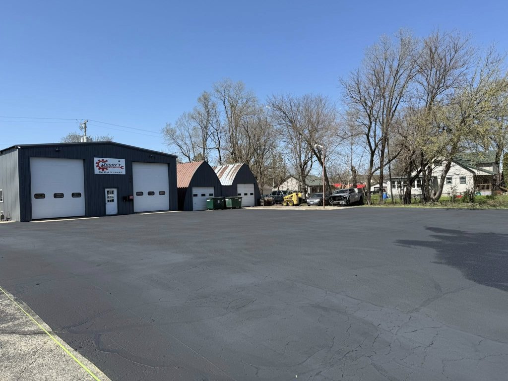 Freshly sealcoated commercial parking lot at Danny's Auto Repair in Portage, WI.