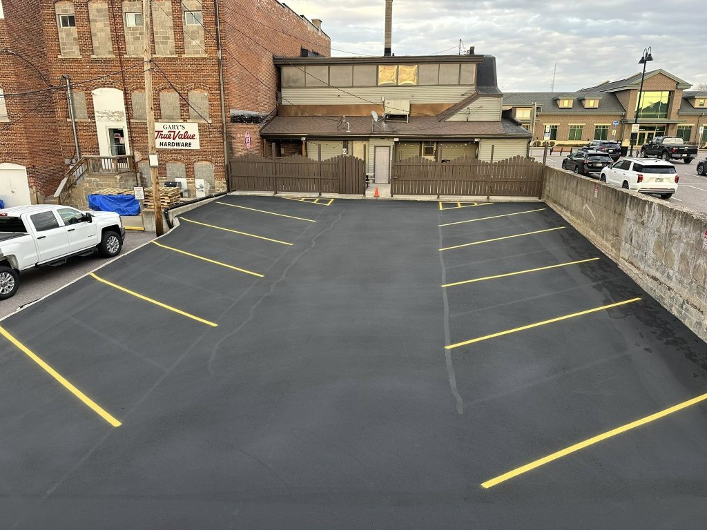 Commercial parking lot freshly sealcoated and line-striped by Cimaroli Sealcoating at Fisher's Bar in Wisconsin Dells, WI.