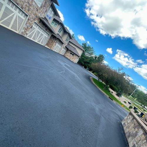 Freshly sealcoated parking lot at an apartment complex in Middleton, WI, completed by Cimaroli Sealcoating.