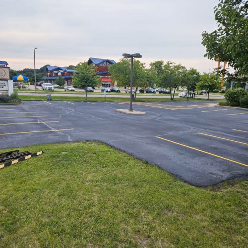 Freshly sealcoated and line-striped parking lot for Aquility Float Spa in Wisconsin Dells, WI, completed by Cimaroli Sealcoating.