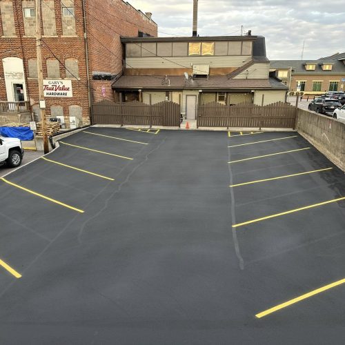 Commercial parking lot freshly sealcoated and line-striped by Cimaroli Sealcoating at Fisher's Bar in Wisconsin Dells, WI.