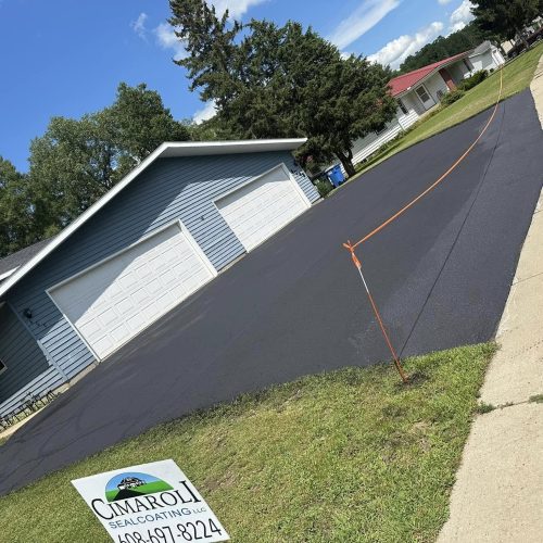 Completed driveway repair and sealcoating project, showcasing a smooth and rejuvenated asphalt surface in Wisconsin Dells, WI.