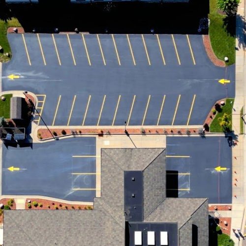 Close aerial view of a freshly sealcoated and striped parking lot at the Bank of Wisconsin Dells Lake Delton Branch