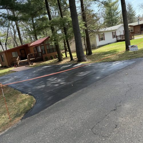 Driveway repair and sealcoating work done by Cimaroli Sealcoating at a Lake Delton home.