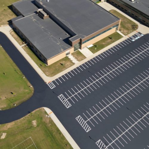 Aerial view of the parking lot at Wisconsin Dells High School, newly sealcoated and striped for a sleek appearance.